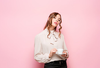 Image showing The serious frustrated young beautiful business woman on pink background