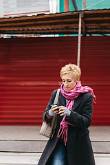 Image showing Woman with phone on city street