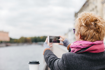 Image showing Woman taking shots from waterfront