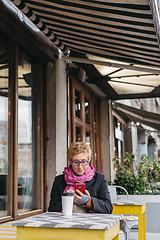 Image showing Woman with drink and smartphone