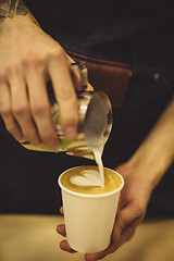 Image showing Bartender pouring coffee to cup