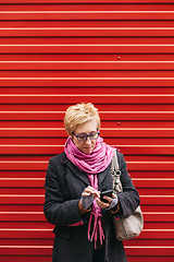 Image showing Adult woman with smartphone on street