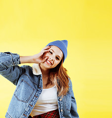 Image showing lifestyle people concept: pretty young school teenage girl having fun happy smiling on yellow background