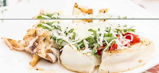 Image showing Cuttlefish with tomato, salad and Parmigiano cheese