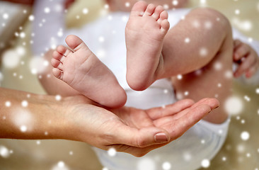 Image showing close up of newborn baby feet in mother hands