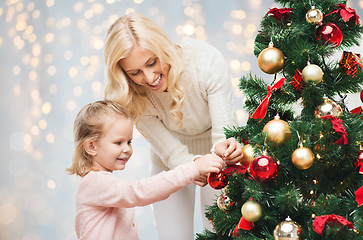 Image showing mother and daughter decorating christmas tree