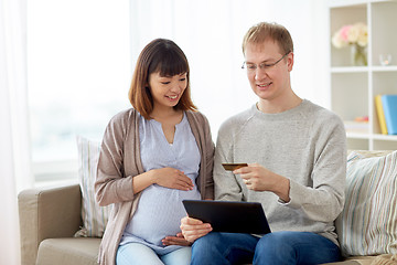 Image showing husband and pregnant wife shopping online at home