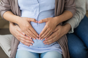 Image showing close up of pregnant woman making hand heart