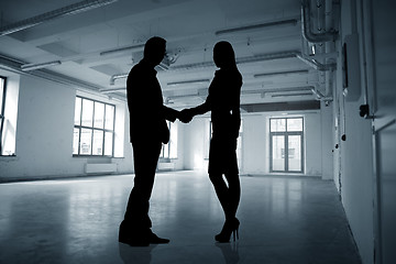 Image showing business people shaking hands over city background