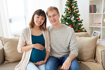 Image showing pregnant wife with husband at home at christmas