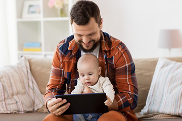 Image showing happy father and baby boy with tablet pc at home