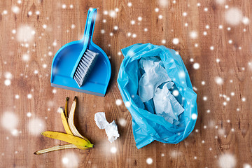 Image showing rubbish bag with trash, whisk and dustpan on floor