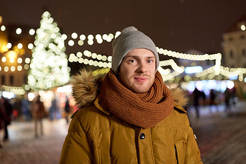 Image showing happy man in winter clothes at christmas market