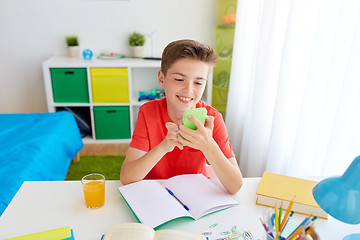 Image showing student boy with smartphone distracting from study