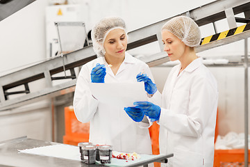 Image showing women technologists tasting ice cream at factory