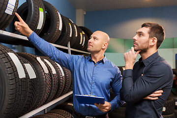 Image showing customer and salesman at car service or auto store