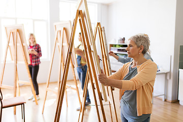 Image showing artist with easel and pencil drawing at art school