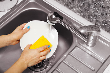 Image showing woman that washes a white dish