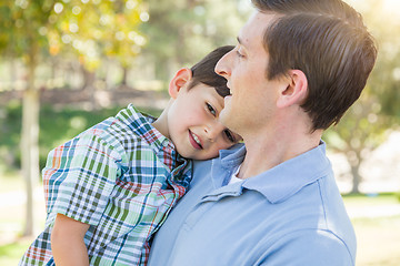 Image showing Happy Caucasian Father and Son Playing Together in the Park.