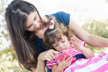 Image showing Mixed Race Mother and Cute Baby Daughter Playing with Cell Phone