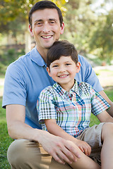 Image showing Mixed Race Father and Son Playing Together in the Park.