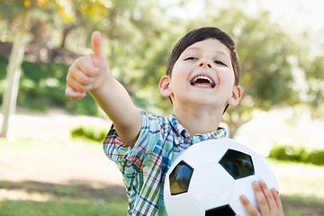 Image showing Cute Young Boy Playing with Soccer Ball and Thumbs Up Outdoors i