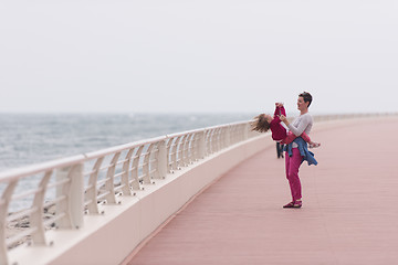 Image showing mother and cute little girl on the promenade by the sea