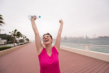 Image showing young woman celebrating a successful training run