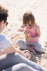 Image showing Mom and daughter on the beach