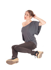 Image showing Woman sitting on floor and looking up