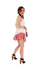 Image showing Young lovely woman in shorts looking back