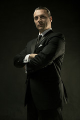 Image showing The attractive man in black suit on dark background