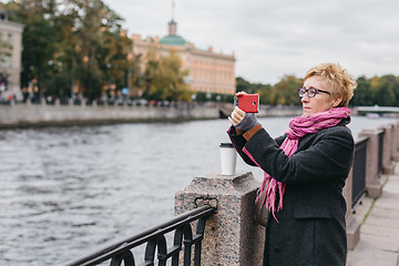 Image showing Woman taking shots on waterfront