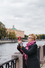 Image showing Woman taking shots on waterfront