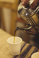 Image showing Tea pouring in cup