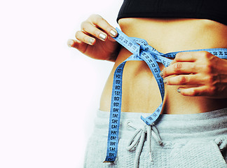 Image showing woman measuring waist with tape on knot like a gift, african tan