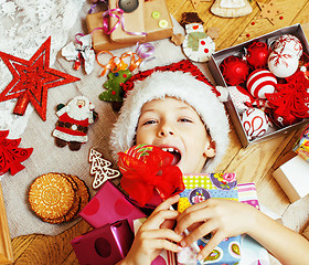 Image showing little cute boy with Christmas gifts at home. close up emotional