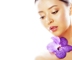 Image showing young pretty asian woman with flower orchid close up isolated