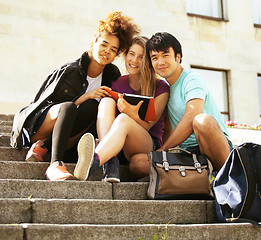 Image showing cute group of teenages at the building of university with books huggings, back to school