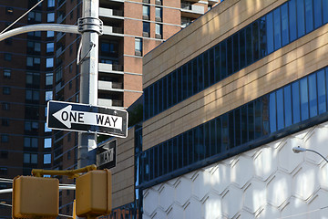 Image showing ONE WAY road sign points left on New York street