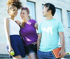 Image showing cute group of teenages at the building of university with books huggings, back to school