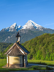 Image showing Vertical view of small chapel and snowy summit of Watzmann mount