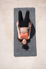 Image showing woman doing morning yoga exercises top view