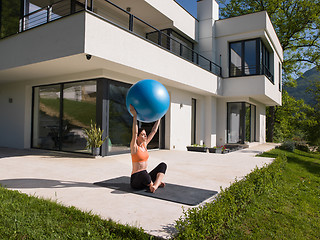 Image showing woman doing exercise with pilates ball