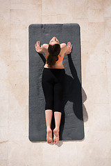 Image showing woman doing morning yoga exercises top view