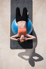 Image showing woman doing exercise with pilates ball top view