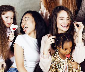 Image showing Lifestyle and people concept: young pretty diversity nations woman with different age children celebrating on birth day party together happy smiling, making selfie. African-american, asian and caucasi