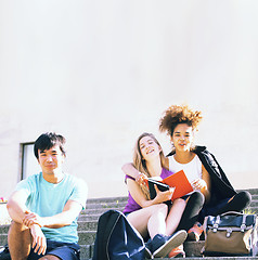 Image showing cute group of teenages at the building of university with books huggings, back to school