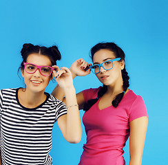 Image showing best friends teenage school girls together having fun, posing emotional on blue background, besties happy smiling, lifestyle people concept 