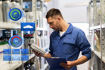 Image showing auto mechanic with clipboard at car workshop